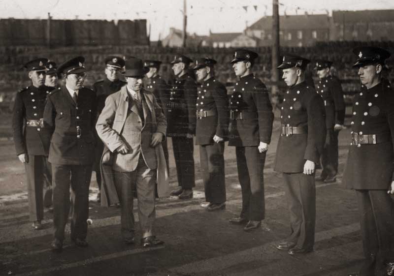 John Jeffers escorting gentleman (No. 5) in civilian dress inspecting AFS section